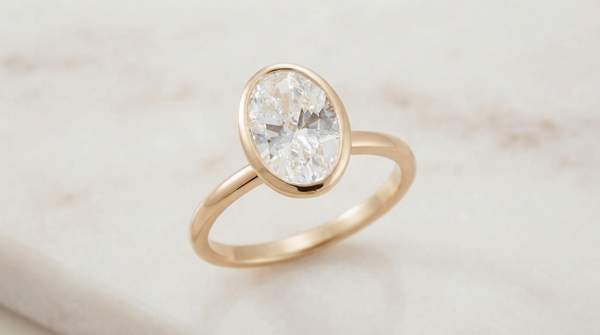 Editorial illustration for Prong or Bezel? Choosing an Oval Diamond Setting That Matches Your Priorities